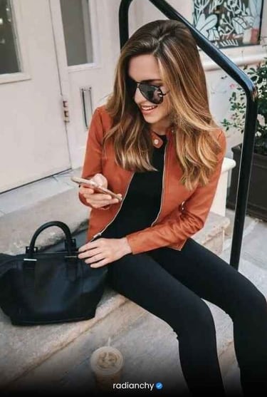 a woman in a black jacket and black pants