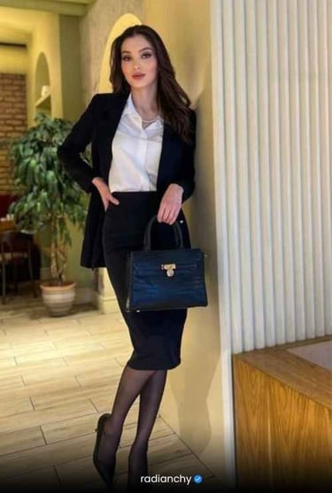 a woman in a black suit and white shirt