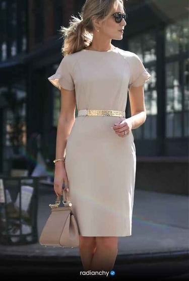 a woman in a white dress and sunglasses