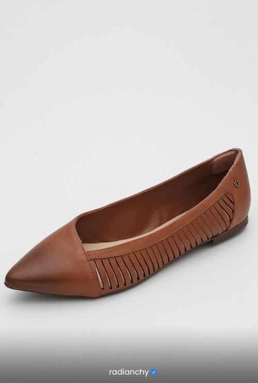 a woman's shoes with a brown leather slipper