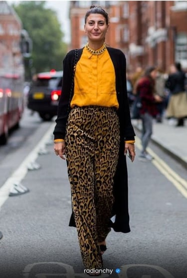 a woman in a yellow blouse and leopard print pants