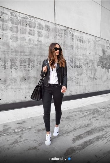 a woman in black jeans and white shirt