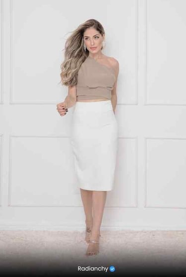 a woman in a white skirt and crop top