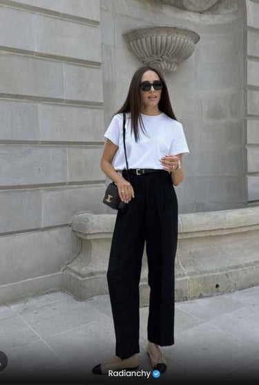 a woman in a white shirt and black pants