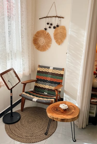 Comfortable balcony reading nook with soft cushions, greenery, and a small table for coffee and book