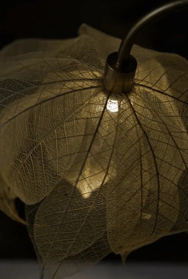 Close-up of a warm leaf-shaped decorative lamp creating soft light for a quiet reading corner.