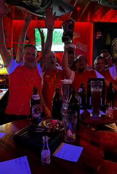 a group of people standing around a bar