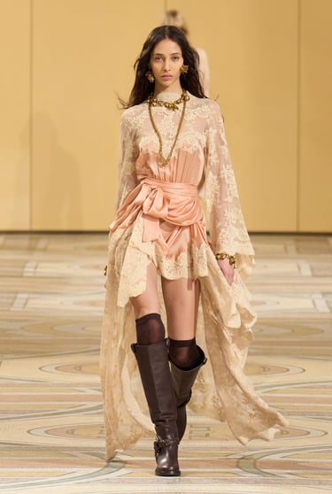 a woman in a dress and boots walking down a runway Fall 2025 ready to wear zimmerman