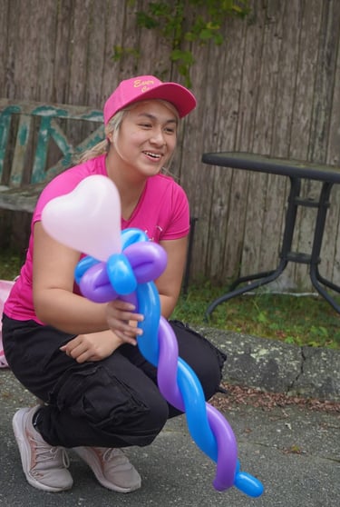 Handing a balloon to a child