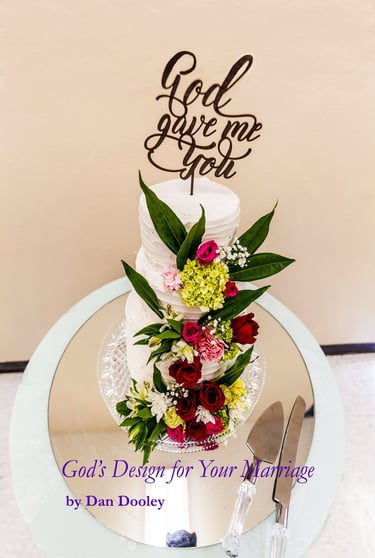 Elegant tiered white wedding cake with fresh red roses and a God Gave Me You topper.