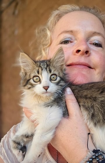 Sunni Dawson smiling with a cat companion during animal communication session