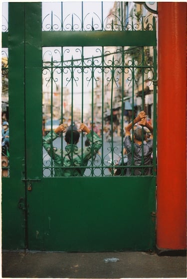 Two man next to the church gate in Saigon China town shot on film