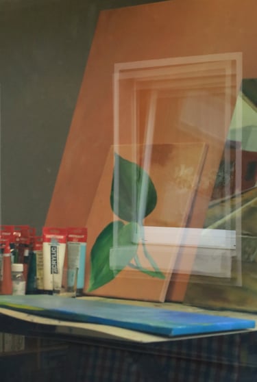 Acrylic leaf painting on canvas sitting on a studio easel next to professional paint tubes.