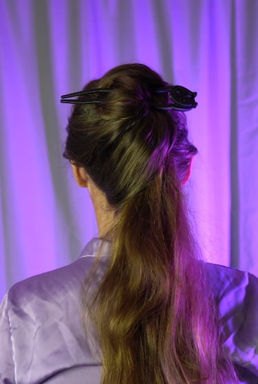 a woman with a ponytail in her hair