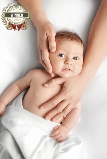 a baby is holding a baby in a blanket winner afns award