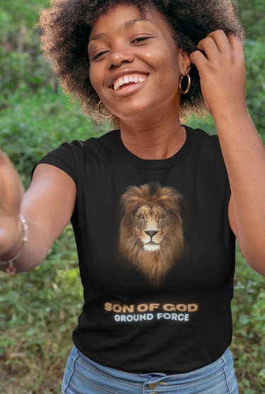 Smiling woman wearing black "Son of God Ground Force" t-shirt with lion face design.