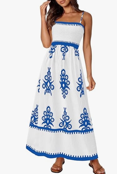 Women's white maxi sun dress with blue floral print and smocked bodice for summer fashion.