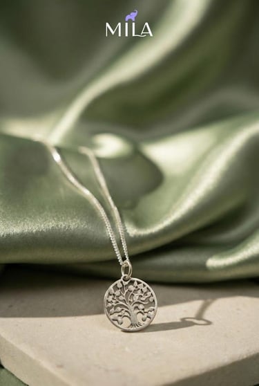 a silver necklace with a tree on it