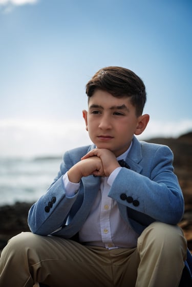 a young man in a blue suit and a white shirt