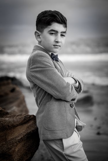 a young boy in a suit and tie