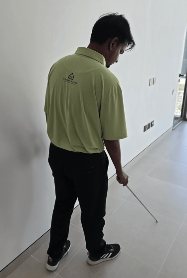 Snagging engineer inspecting hollow tiles using tile hammer rod in Dubai apartment