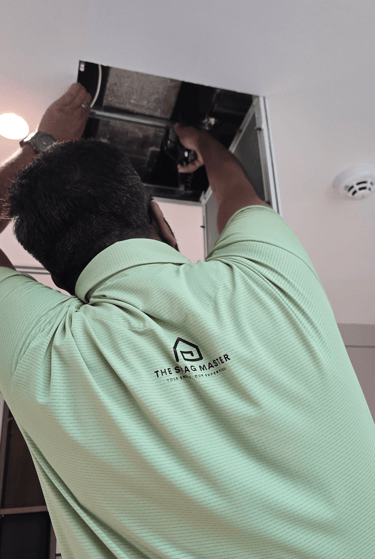Snagging engineer inspecting false ceiling duct with flashlight in Dubai villa