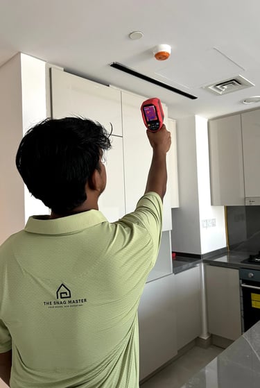 An engineer is using thermal camera to inspect leak in an apartment