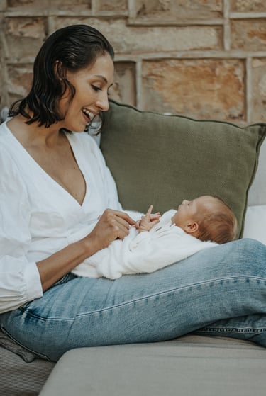 natural, lifestyle newborn photograph of baby looking up at mom