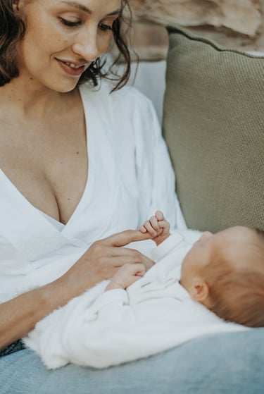 natural, lifestyle newborn photograph of baby holding on to moms finger