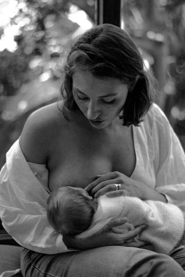 natural, lifestyle newborn photograph of baby breastfeeding 