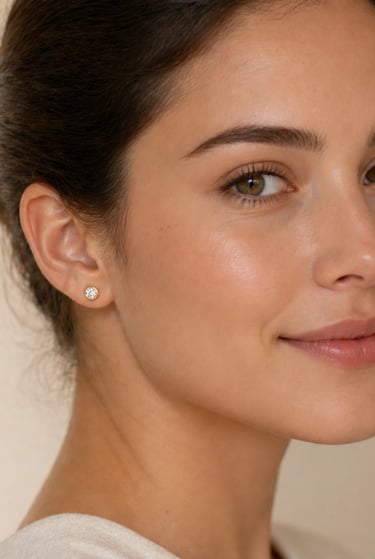 Woman wearing small gold stud earrings with clean and minimal professional styling
