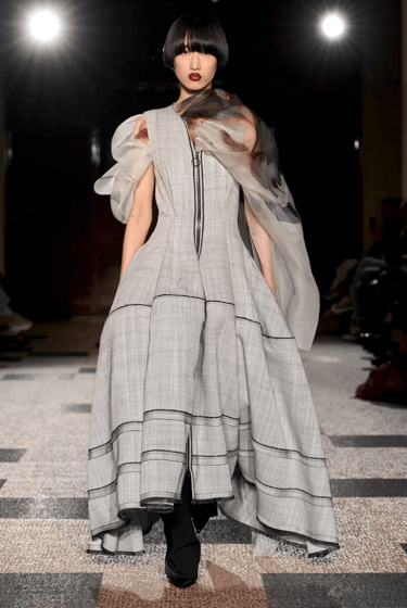 Roksanda model in grey sculptural dress with sheer scarf on the runway at London Fashion Week 2026.