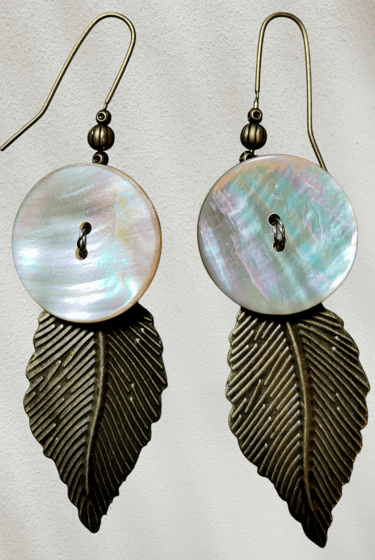 Iridescent mother of pearl shell and antique bronze leaf dangle earrings for boho jewelry fashion.