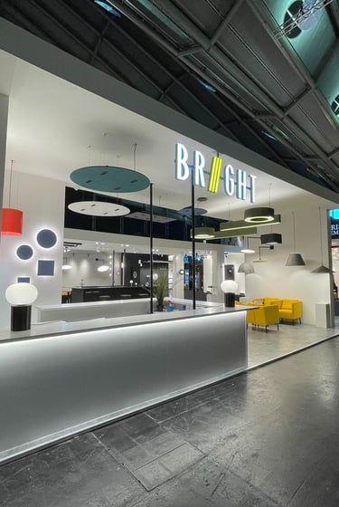 Modern exhibition booth with sleek white design and integrated lighting at trade show