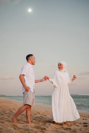 Ilham family walking together along Melasti Beach Bali during a calm sunset family session