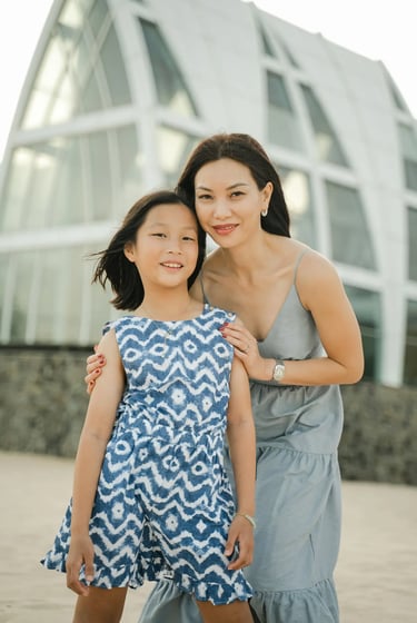 Mother and daughter sharing a joyful moment during a family photography session at The Ritz-Carlton Bali.