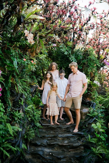 Family portrait surrounded by tropical gardens during a Bali family photography session in Ubud