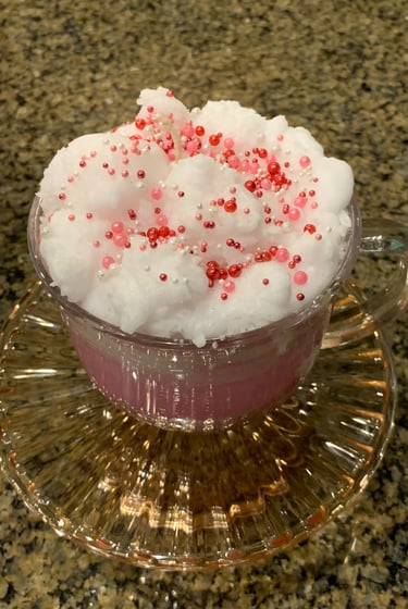 Candle in glass cup with "froth" on top