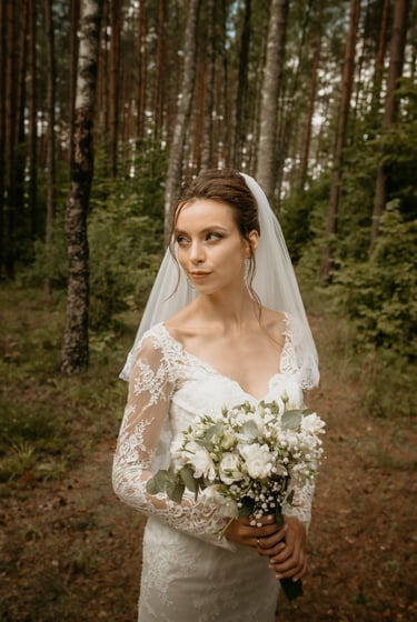 a woman in a wedding dress and veil with a veil on her head