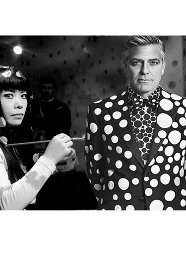an artist Kusama painting  a man George Clooney in polka dotty dress clothes