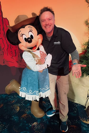 Minnie's Travel Boutique co-owner Chris Breedlove pictured with Minnie Mouse at The Disneyland® Hotel.