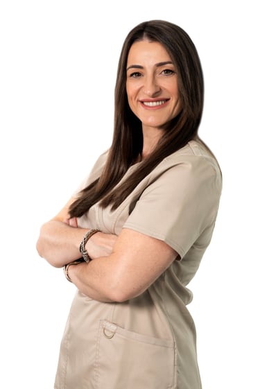 a woman in a nurse's uniform smiling and holding her arms crossed, dentista