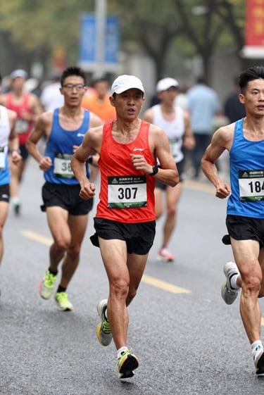 A male runner starting a race on a track.