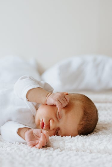 portrait de nouveau né amenant ses mains au visage