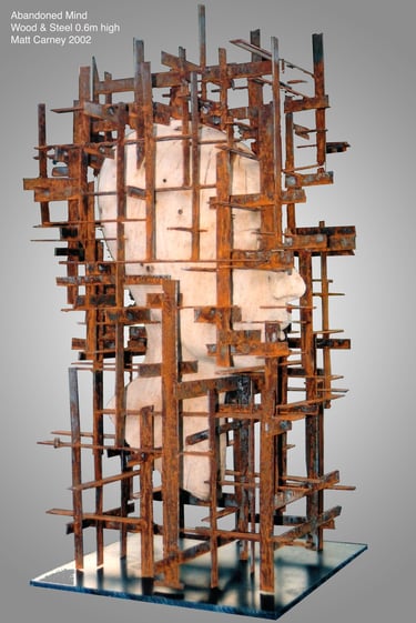 a sculpture of a wooden head encased in a rusted grid