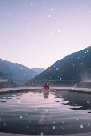 A person soaking in a steaming outdoor thermal pool at Aqua Dome while light snow falls, showcasing 