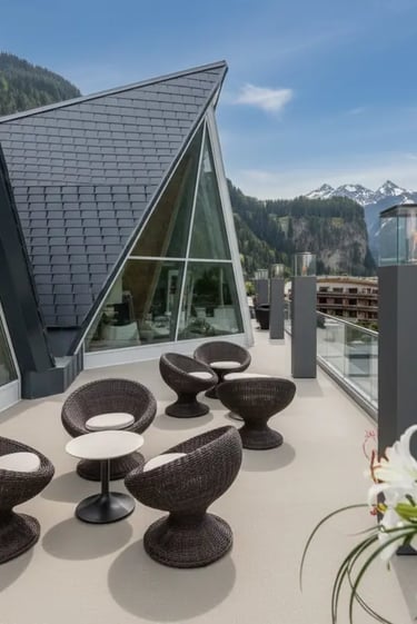 Modern outdoor lounge terrace at Aqua Dome with stylish dark wicker chairs and a view of the contemp