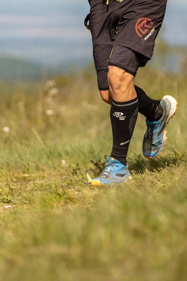 a man running on a grassy field with a soccer ball