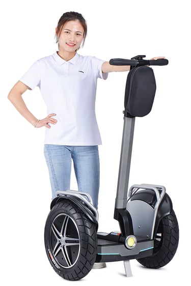 a woman standing in front of a segway