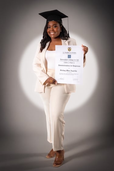 a woman in a white suit and a graduation cap